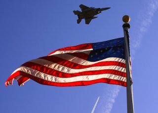 American Flag with jet flying over